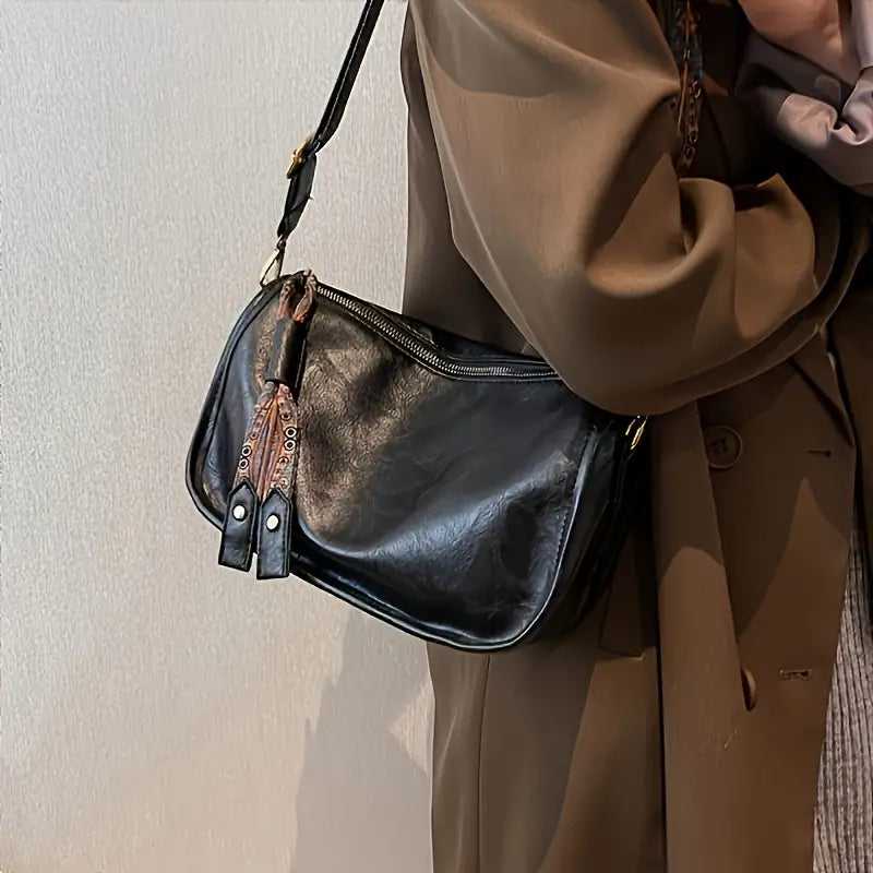 Bolso cruzado con cremallera y estampado gráfico